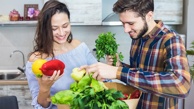 couple unloading groceries at home